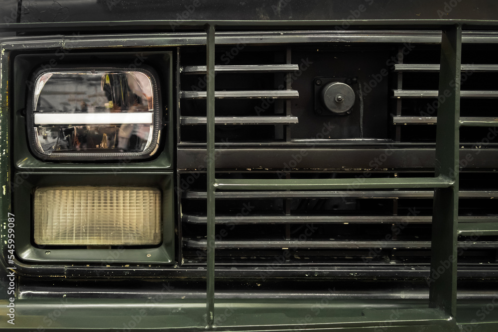 Fototapeta premium Photo of an old green car. Headlight. Retro automobile