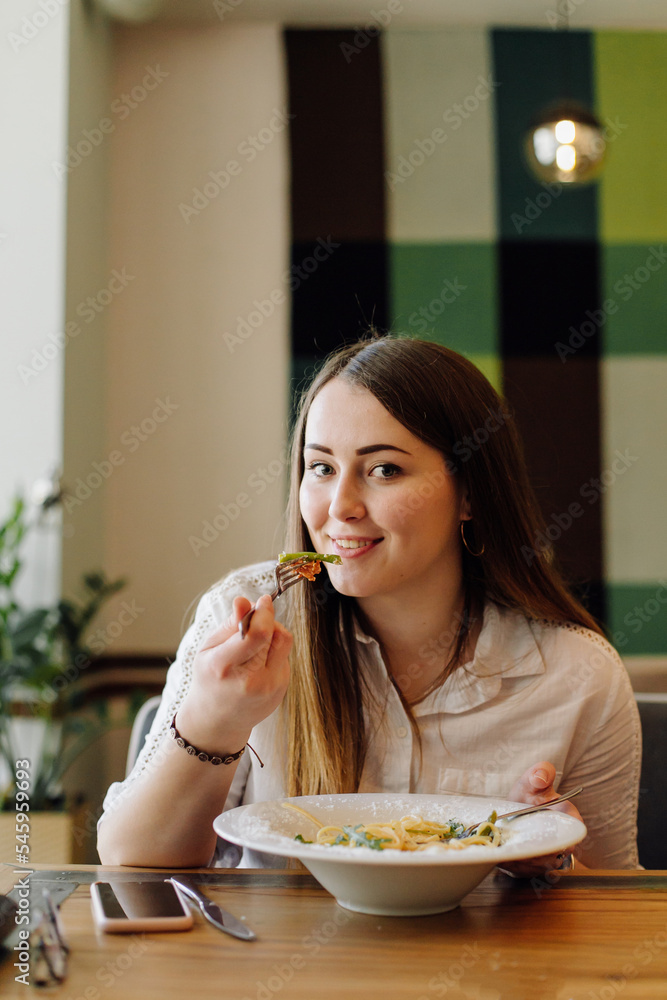 Friends enjoying lunch in the restaurant, eating paste Friends enjoying lunch in the restaurant, eating paste