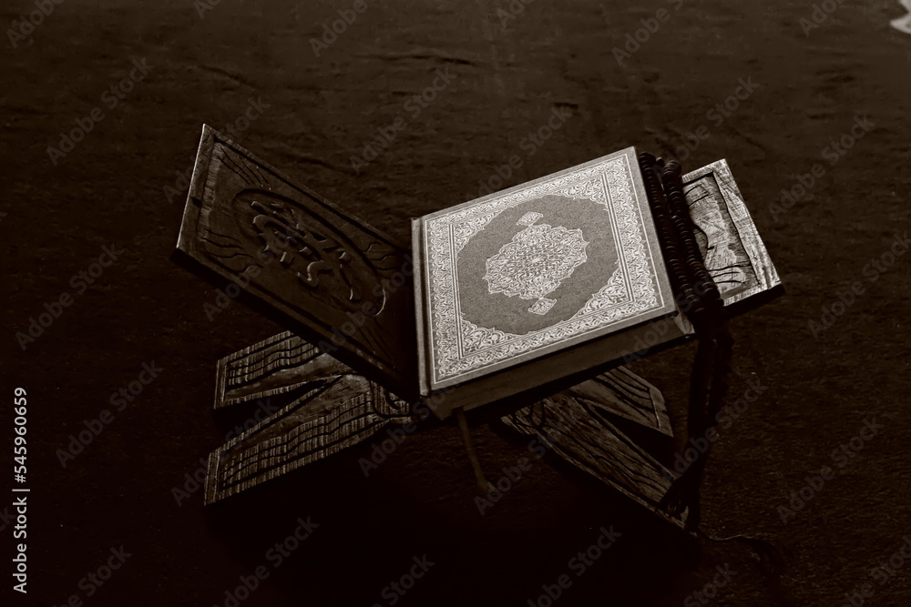 The Holy Alquran, holy book of Muslims and wooden prayer beads in a mosque