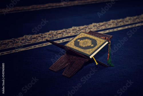 The Holy Alquran, holy book of Muslims and wooden prayer beads in a mosque