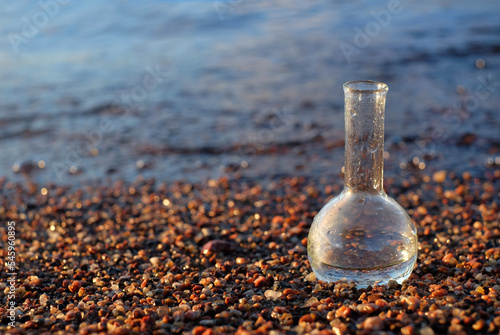 Water sample on seaside background for analiysis. Ecology concept, with copy space