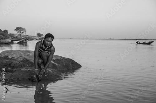 Canvas-taulu Black and White portrait of Africa woman fetching water from the River