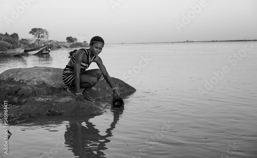 Tablou canvas Black and White portrait of Africa woman fetching water from the River
