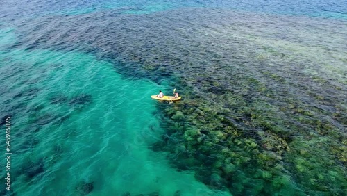 Canoeing over Coral Reef in Papua New Guinea photo