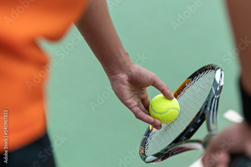 Man play tennis ball and tennis racquet, Professional tennis player, Sport and healthy lifestyle, concept of outdoor game sports, racket and green ball. © Meaw_stocker