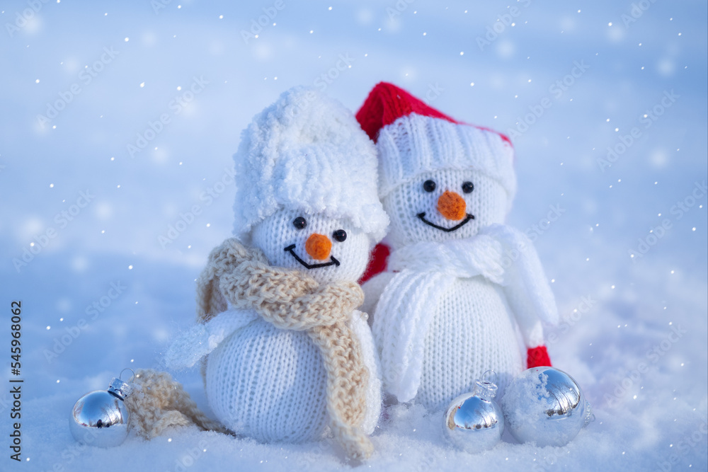 A couple of happy snowmen outside in the snow. Festive Christmas Greeting Card A couple of happy snowmen outside in the snow. Festive Christmas Greeting Card