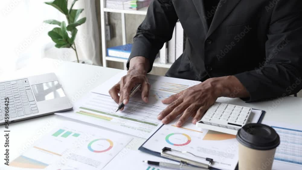 Close up a man working about financial with calculator at his office to calculate expenses, Accounting concept Close up a man working about financial with calculator at his office to calculate expenses, Accounting concept
