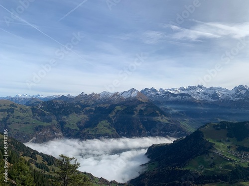 lake in the mountains with clouds hovering above in nidwalden switzerland