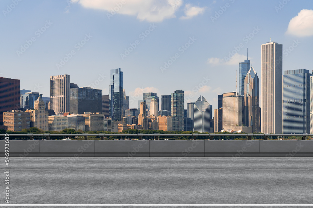 Empty urban asphalt road exterior with city buildings background. New modern highway concrete construction. Concept of way to success. Transportation logistic industry fast delivery. Chicago. USA. Empty urban asphalt road exterior with city buildings background. New modern highway concrete construction. Concept of way to success. Transportation logistic industry fast delivery. Chicago. USA.