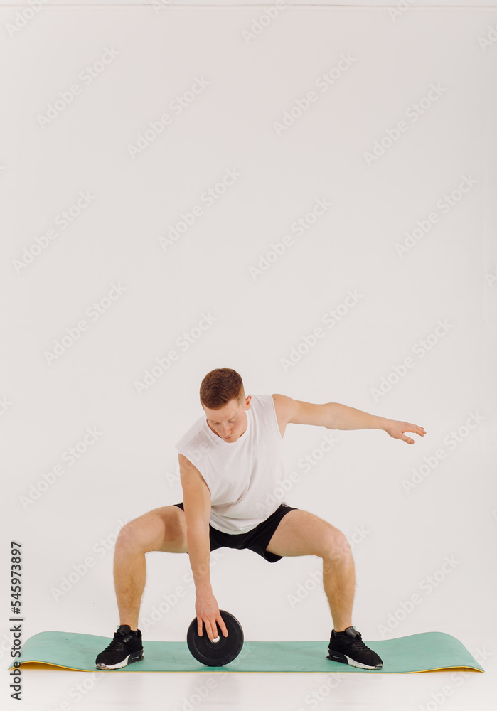 Athletic young man doing workouts at home, man doing training, warm up before weight exercise. Athletic young man doing workouts at home, man doing training, warm up before weight exercise.