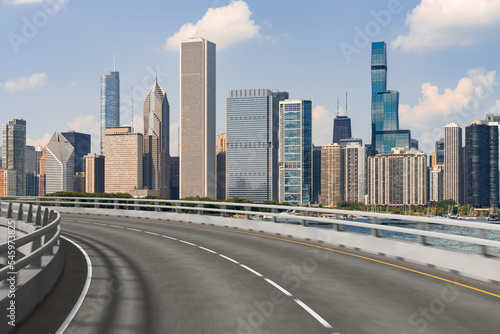 Empty urban asphalt road exterior with city buildings background. New modern highway concrete construction. Concept of way to success. Transportation logistic industry fast delivery. Chicago. USA.