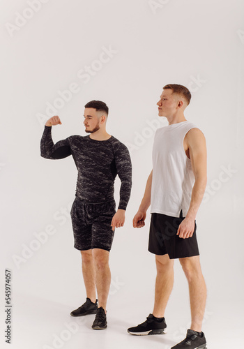 Athletic young man doing workouts at home, man doing training, warm up before weight exercise.