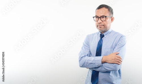 Photos 40-50 years old Asian businessman folded his arms and smiled happily after successfully investing in finance, banking, real estate, oil, petroleum