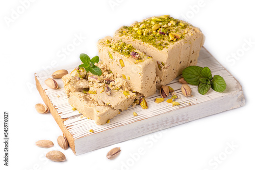 Sesame halva with pistachios on grey background. Top view. Copy space. Traditional middle eastern sweets. Jewish, turkish, arabic national dessert. Turkish delight.