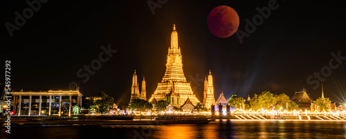 BANGKOK, THAILAND - November 8, 2022 : Lunar Eclipse,  Super Red Full Moon taken from top side of “Wat Arun Temple”,  This is a wonderful natural phenomenon with the view along Chao Praya River. © Bobbyphotos