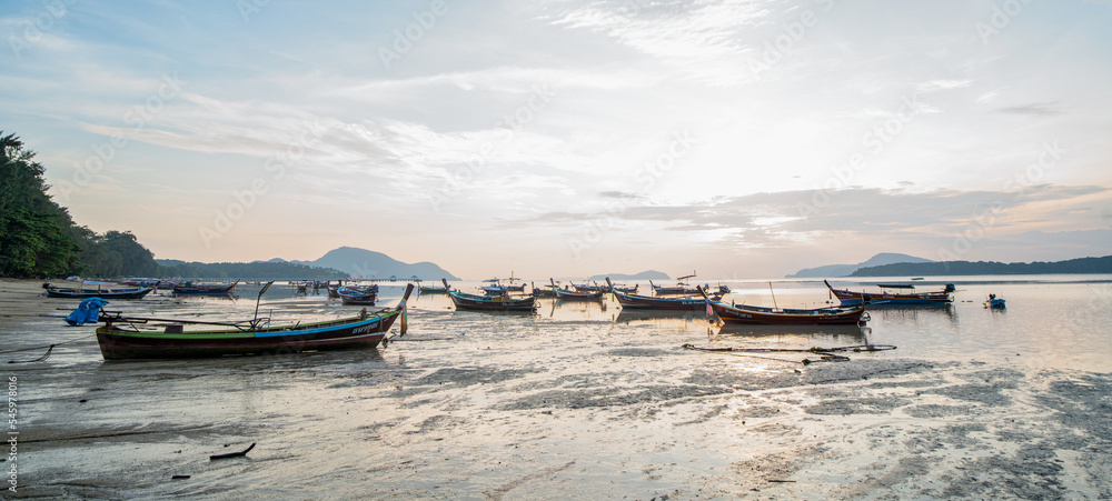 Beautiful landscape of tropical coast with traditional long tail boats, Phuket island, Thailand. Morning light.