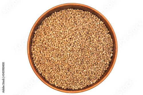 buckwheat in a clay bowl on a white background. the concept of a good harvest of buckwheat