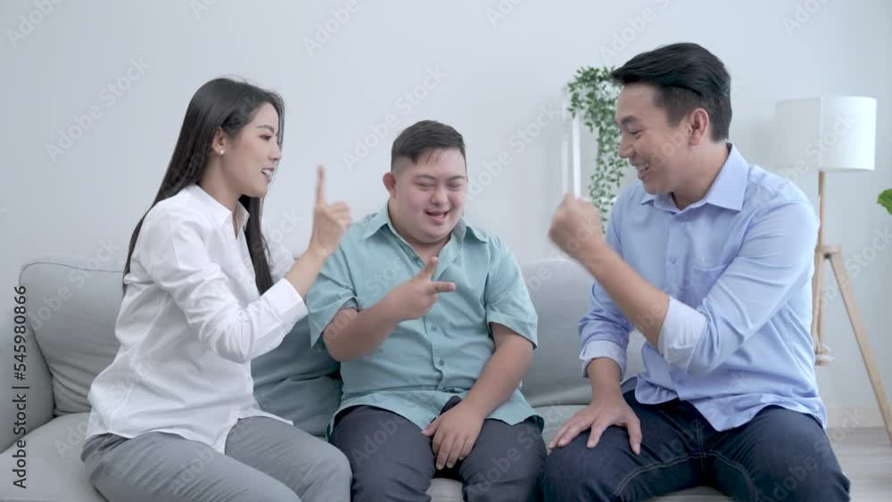 Asian parents and autistic son spend their leisure time together happily at home. Asian parents and autistic son spend their leisure time together happily at home.