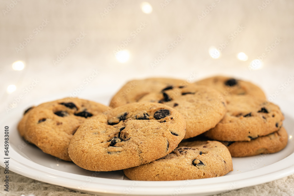 Cookies with chocolate chips close-up on blurred background with lights. Cookies with chocolate chips close-up on blurred background with lights.