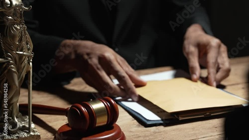 Wallpaper Mural legal advisor The judge handed a document with a contract for the man to sign in court. Close-up of a businessman or lawyer signing a contract and sitting at a desk in a business office. Torontodigital.ca