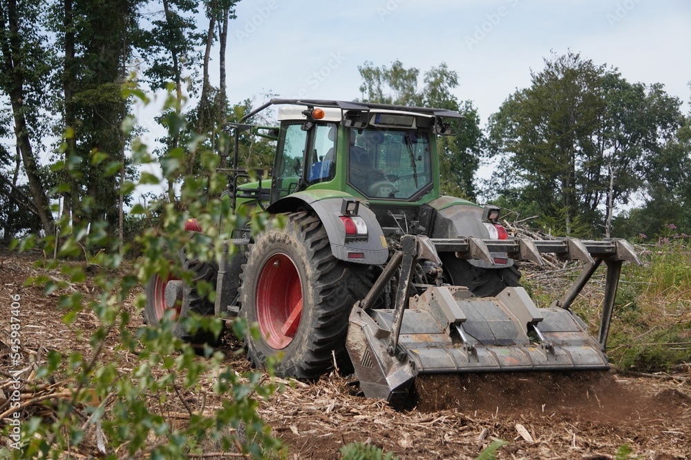 Tractor on a trail in a forest Tractor on a trail in a forest