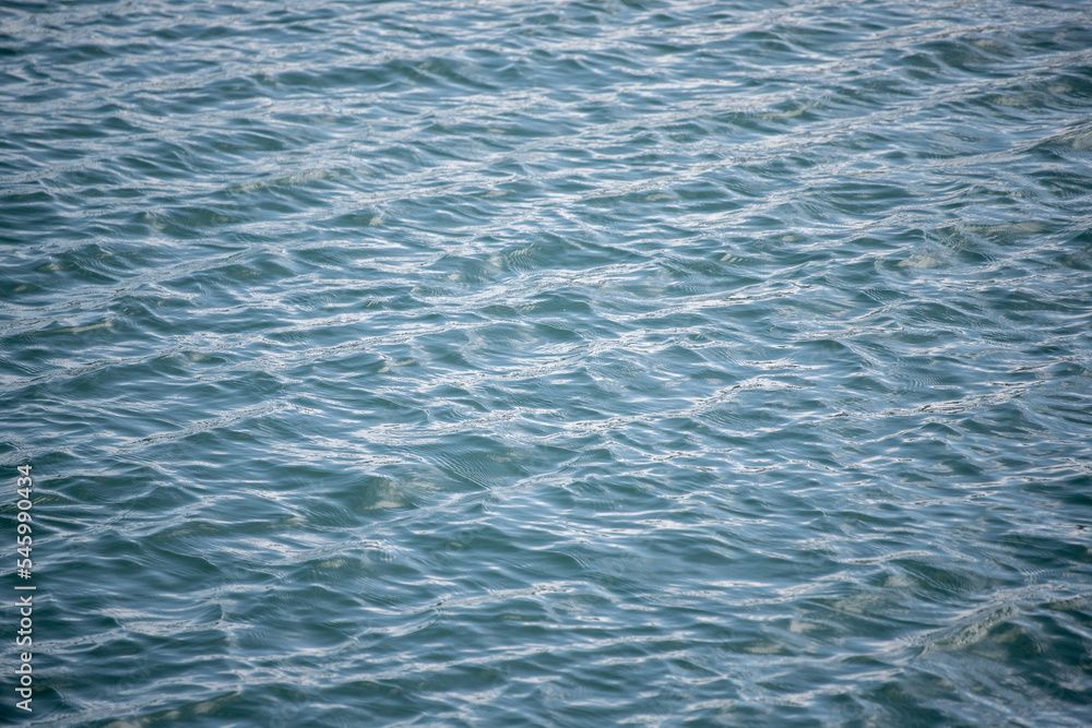 Water surface, abstract background with text box. Texture of water with the sun shine. Water surface, abstract background with text box. Texture of water with the sun shine.