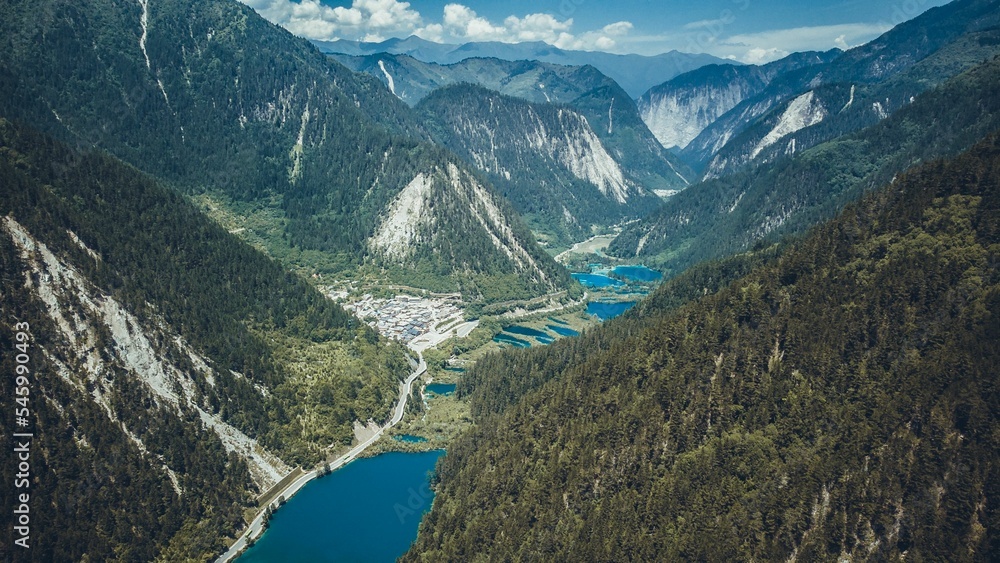 Aerial of the turquoise lake in the scenic Jiuzhaigou valley surrounded by mesmerizing mountains