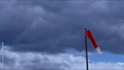 Red and white windbag against a cloudy sky in Bremm Germany