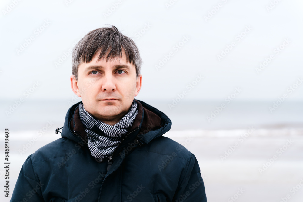 Portrait of a serious relaxed middle-aged man near the winter sea Portrait of a serious relaxed middle-aged man near the winter sea