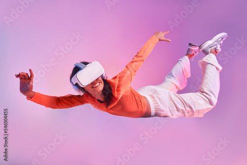 Woman in VR glasses suspended in the air