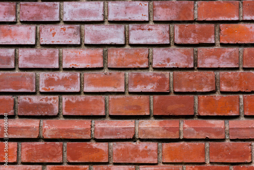 Close up to a red glossy brick wall. Exterior design