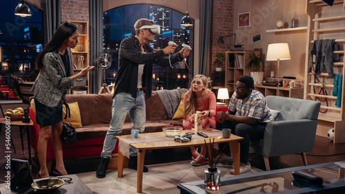 Television Sitcom Concept: Four Friends have Fun in Living Room. Funny Sketch About Two Couples. Guy in VR Headset has Metaverse Addiction. Comedy Show Broadcast on Cable Channel, Streaming Service.