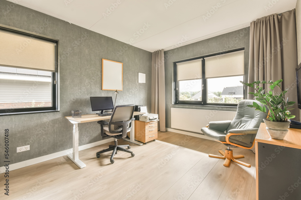 Desk by a bright window with gray walls Desk by a bright window with gray walls