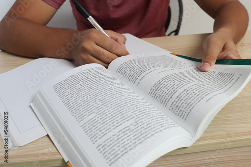 Writing with the pen on the notebook