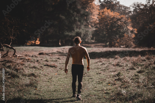 Muscled Spanish man with his back turned walking towards the forest  © FranciscoJavier