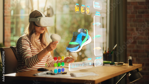 Talented Female Shoes Designer Wearing Virtual Reality Headset and Using Controllers to Design a Fashionable Sneaker in Augmented Reality Software. Woman Working on Digital Footwear at Home. photo
