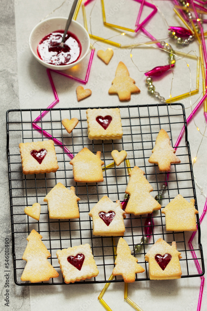 Sugar cookies stuffed with raspberry jam on a light background. Christmas and New Year's decor.