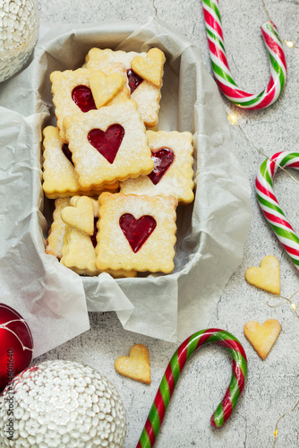 Obraz na płótnie Sugar cookies stuffed with raspberry jam on a light background. Christmas and New Year's decor. w salonie