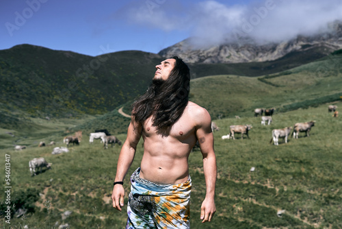 Obraz na plátně young caucasian man with long loose hair, naked torso with a pareo around his wa