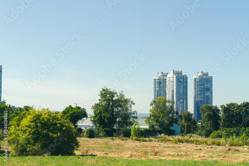 Construction of multi-storey buildings in ecologically clean areas of the city. Multi-storey buildings. Multi-storey houses on the background of a natural park.
