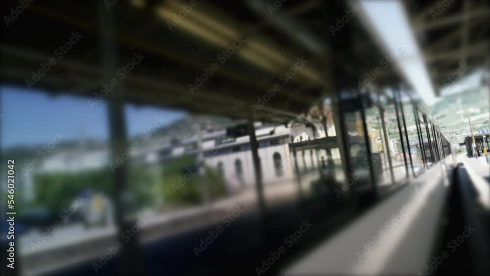 Moving train leaving platform station. Dutch angle of railroad wagon transportation departing Moving train leaving platform station. Dutch angle of railroad wagon transportation departing