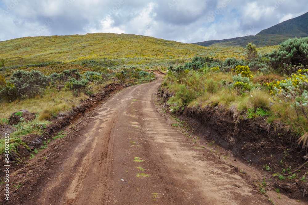 A dirt road against a mountain background at Chogoria Route, Mount Kenya