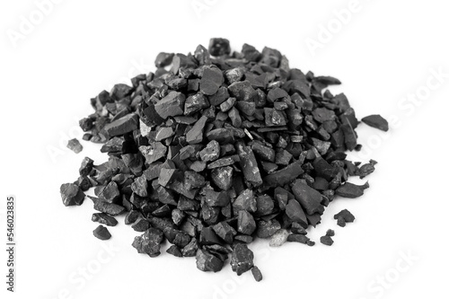 Heap of shungite stones. Natural mineral on a white background. top view photo