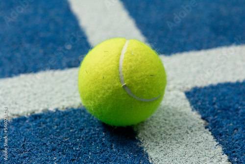 Tennis ball in a blue floor in a panel court © Nuaestudio