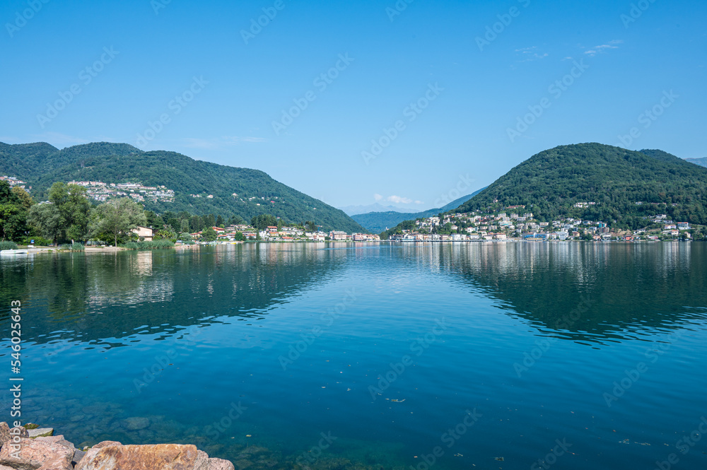 Fototapeta premium Landscape of the Lake Lugano with Ponte Tresa reflecting on the water