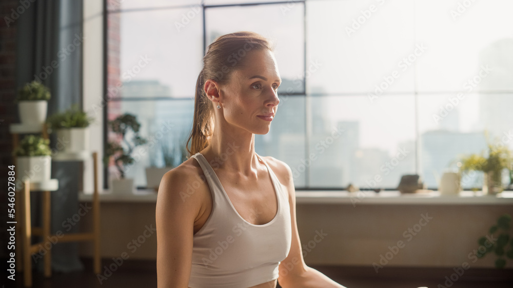 Young Beautiful Female Exercising, Practising Meditation in the Morning in Her Bright Sunny Loft Apartment. Healthcare, Fitness, Wellbeing and Mindfulness Concept. Side View Close Up.