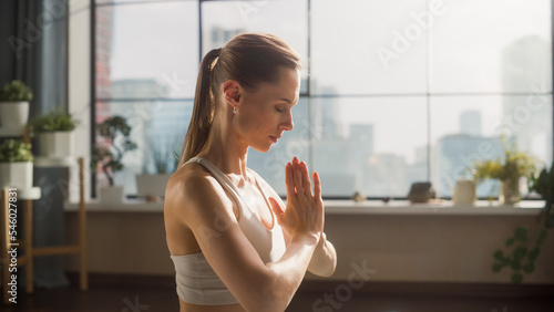 Young Beautiful Female Exercising, Practising Meditation in the Morning in Her Bright Sunny Loft Apartment. Healthy Lifestyle, Fitness, Wellbeing and Mindfulness Concept. Side View. Free Download Young Beautiful Female Exercising, Practising Meditation in the Morning in Her Bright Sunny Loft Apartment. Healthy Lifestyle, Fitness, Wellbeing and Mindfulness Concept. Side View. - GFXLoad