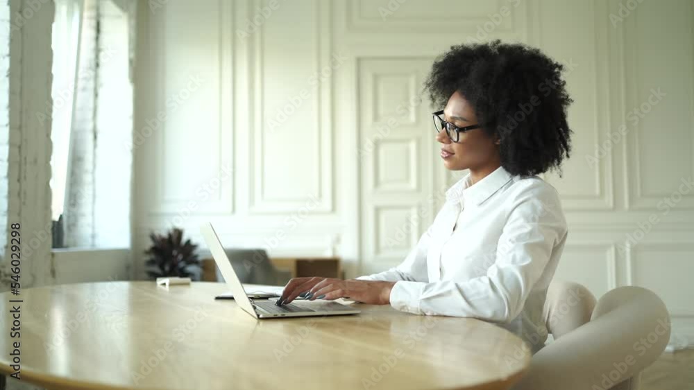 A female freelancer with glasses uses a laptop, works in the office, writes a message online to a colleague in a chat. A female freelancer with glasses uses a laptop, works in the office, writes a message online to a colleague in a chat.