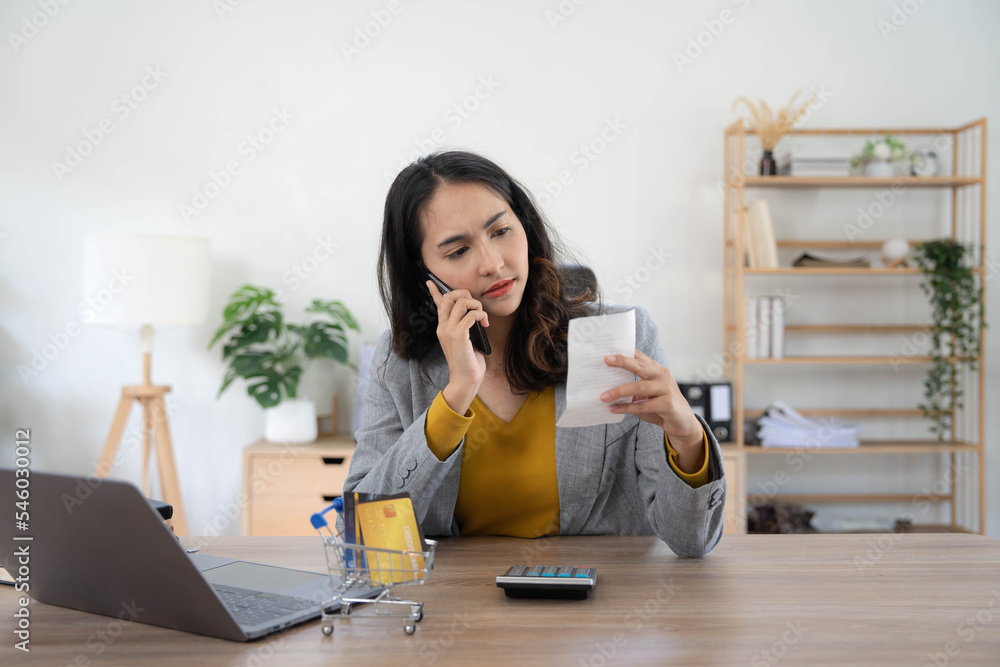Young asian woman calculating expenses household about finance and frustrated on desk at home, girl checking bill having stress and worried, debt and tax, expression and emotion, business concept. Young asian woman calculating expenses household about finance and frustrated on desk at home, girl checking bill having stress and worried, debt and tax, expression and emotion, business concept.