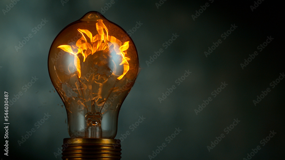 Freeze motion of light bulb exploding, dark background - obrazy, fototapety, plakaty 